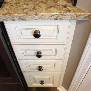 Photo of a mid-sized transitional galley kitchen pantry in Cleveland with an undermount sink, raised-panel cabinets, beige cabinets, quartz benchtops, multi-coloured splashback, mosaic tile splashback, stainless steel appliances, with island and beige benchtop.