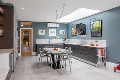 Photo of a large classic u-shaped kitchen/diner in London with shaker cabinets, grey cabinets, quartz worktops, ceramic flooring, no island and feature lighting.