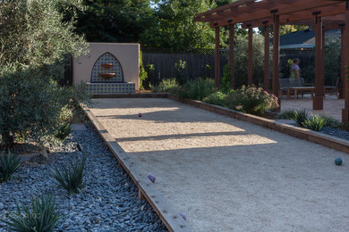 This is an example of a mid-sized mediterranean backyard full sun outdoor sport court in Sacramento with decomposed granite.