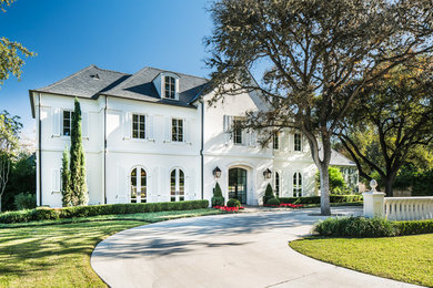 Large trendy white three-story exterior home photo in Austin