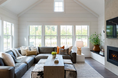 Living room - modern open concept dark wood floor, brown floor, vaulted ceiling and shiplap wall living room idea in Other with white walls, a standard fireplace, a concrete fireplace and a wall-mounted tv