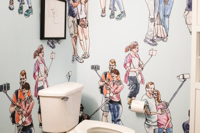 Powder room - small contemporary brown floor powder room idea in Austin with a two-piece toilet and multicolored walls