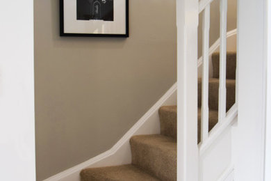 Inspiration for a contemporary wood wood railing staircase in West Midlands with wood risers.