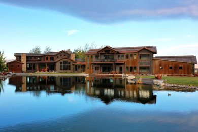 Inspiration for a large rustic brown three-story house exterior remodel in Other