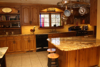 Eat-in kitchen - large traditional l-shaped ceramic tile eat-in kitchen idea in Other with a double-bowl sink, raised-panel cabinets, medium tone wood cabinets, granite countertops, black appliances and a peninsula