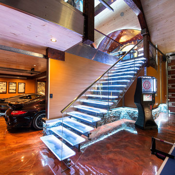 Glass private bar and glass stair treads inside a man cave in Michigan