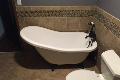 Example of a mid-sized 1950s brown tile and porcelain tile bathroom design in Miami with a two-piece toilet