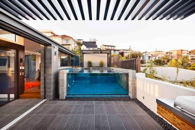 Design ideas for a contemporary courtyard custom-shaped aboveground pool in Sydney.