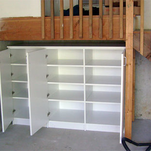 Closed office supplies storage cabinet under entry stairs