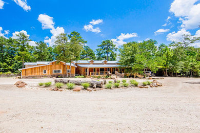Example of a large southwest one-story wood exterior home design in Houston