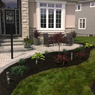 Mid-sized modern front yard patio in Ottawa with brick pavers.