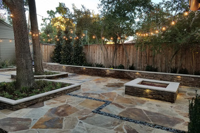 Mid-sized traditional backyard partial sun formal garden in Dallas with a container garden and natural stone pavers for summer.
