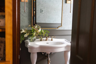 Inspiration for a small timeless ceramic tile, multicolored floor and wainscoting powder room remodel in Other with green walls, a console sink and a freestanding vanity