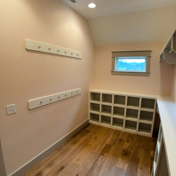 Elegant Guest Closet Organization: White Built-Ins, Open Cubbies, and Hanging St