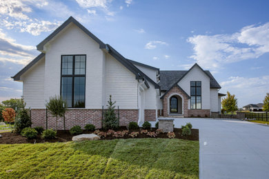 One-story mixed siding exterior home photo in Omaha with a shingle roof and a black roof