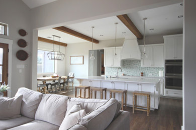 Inspiration for a country vinyl floor and brown floor kitchen remodel in Austin with shaker cabinets, white cabinets, blue backsplash, stainless steel appliances, an island and white countertops