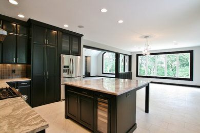 Large modern u-shaped kitchen in Chicago with an undermount sink, recessed-panel cabinets, black cabinets, quartzite benchtops, brown splashback, ceramic splashback, stainless steel appliances, with island and white floor.