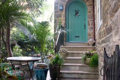 Example of a small eclectic two-story stone exterior home design in Philadelphia