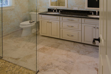 Inspiration for a large contemporary master multicolored tile and porcelain tile porcelain tile walk-in shower remodel in Raleigh with an undermount sink, raised-panel cabinets, white cabinets, granite countertops and a two-piece toilet