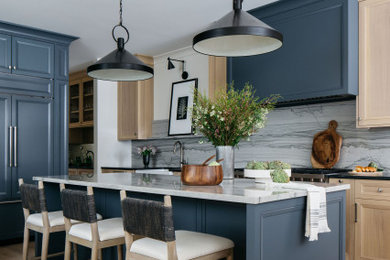 Inspiration for an open concept kitchen remodel in Denver with a farmhouse sink, recessed-panel cabinets, quartzite countertops, paneled appliances and an island