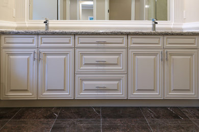 Example of a mid-sized classic master porcelain tile and gray floor bathroom design in Orange County with raised-panel cabinets, white cabinets, beige walls, an undermount sink and granite countertops