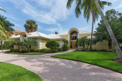 Example of a huge tuscan one-story exterior home design in Miami