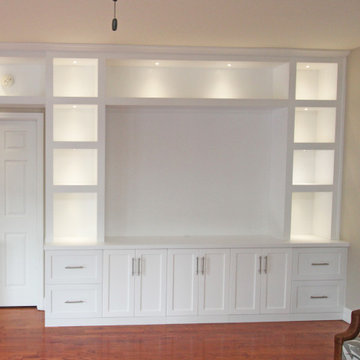 Modern Built-In Entertainment Center along with a Built-in Desk and Cabinetry
