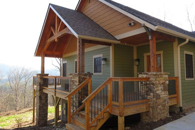 Large arts and crafts multicolored split-level concrete fiberboard exterior home photo in Other