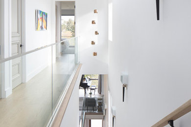 Trendy wooden straight glass railing staircase photo in San Francisco with wooden risers