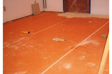 Example of a large trendy look-out porcelain tile basement design in Seattle with white walls