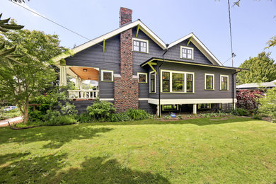Example of a mid-sized arts and crafts blue two-story wood and clapboard exterior home design in Seattle with a shingle roof and a gray roof
