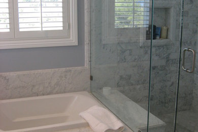 Example of a large transitional master gray tile and marble tile marble floor and multicolored floor bathroom design in Orange County with white cabinets, blue walls, marble countertops, a hinged shower door and white countertops