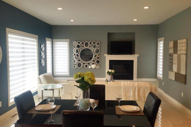 Kitchen/dining room combo - mid-sized contemporary ceramic tile and beige floor kitchen/dining room combo idea in Calgary with blue walls and a standard fireplace