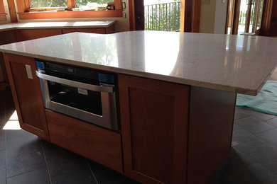 Transitional kitchen photo in Phoenix with recessed-panel cabinets, medium tone wood cabinets and an island