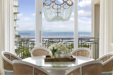 Example of a mid-sized beach style vinyl floor, brown floor and wallpaper kitchen/dining room combo design in Miami with white walls