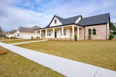 Inspiration for a cottage one-story house exterior remodel in New Orleans with a shingle roof and a black roof