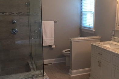 Example of a mid-sized classic master beige tile and ceramic tile ceramic tile bathroom design in Richmond with recessed-panel cabinets, white cabinets, a one-piece toilet, beige walls, an undermount sink and granite countertops