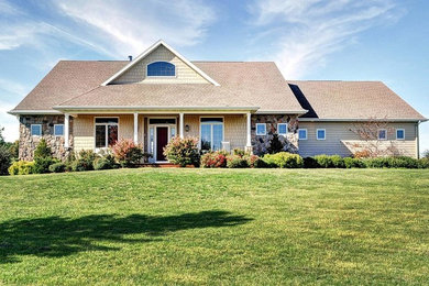 Example of a mid-sized trendy beige two-story concrete fiberboard exterior home design in Milwaukee