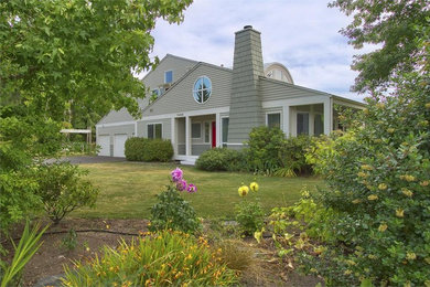 Large trendy gray two-story wood exterior home photo in Seattle