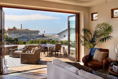 Mid-sized island style formal and open concept medium tone wood floor living room photo in Los Angeles with beige walls, no fireplace and no tv