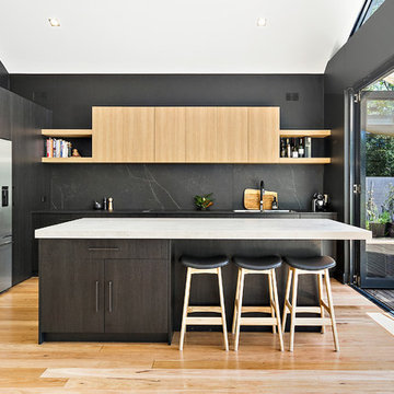 Minimalist kitchen with black and timber cabinets