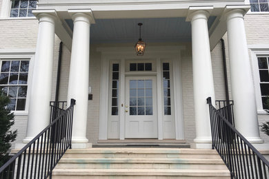 Inspiration for a huge timeless metal railing balcony remodel in DC Metro with a roof extension