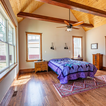 Single-hung windows, French door help bring in the light in bedroom