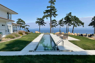 Large elegant backyard concrete and rectangular lap pool photo in Vancouver