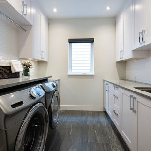 Inspiration for a medium sized contemporary galley separated utility room in Vancouver with a submerged sink, recessed-panel cabinets, white cabinets, engineered stone countertops, beige walls, plywood flooring and a side by side washer and dryer.