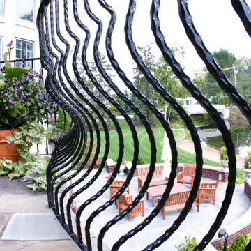 Curved Exterior Staircase with Wrought Iron Balcony Rail