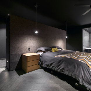 This is an example of a large contemporary master bedroom in Perth with black walls, porcelain floors and no fireplace.