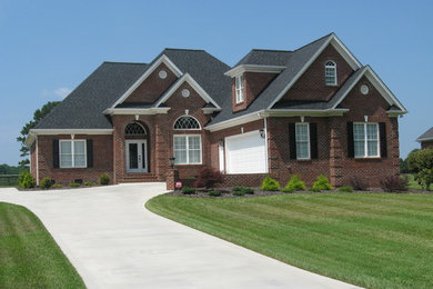 Design ideas for a large traditional two-storey brick exterior in Charlotte.