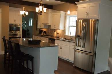 Inspiration for a transitional dark wood floor kitchen remodel in Other with an undermount sink, recessed-panel cabinets, white cabinets, beige backsplash, ceramic backsplash, stainless steel appliances and an island
