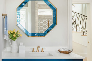 Mid-sized transitional beige tile and stone tile single-sink alcove shower photo in Charlotte with shaker cabinets, blue cabinets, a one-piece toilet, beige walls, an undermount sink, quartz countertops, a hinged shower door, white countertops and a built-in vanity
